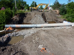The landscape cut open and the pipe to tame our rushing stream.